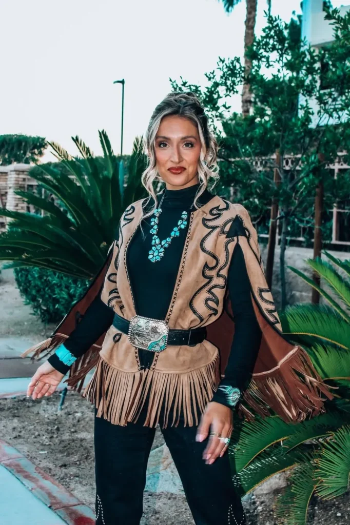 Black Turtleneck with a Tan Fringe Vest and Black Pants
