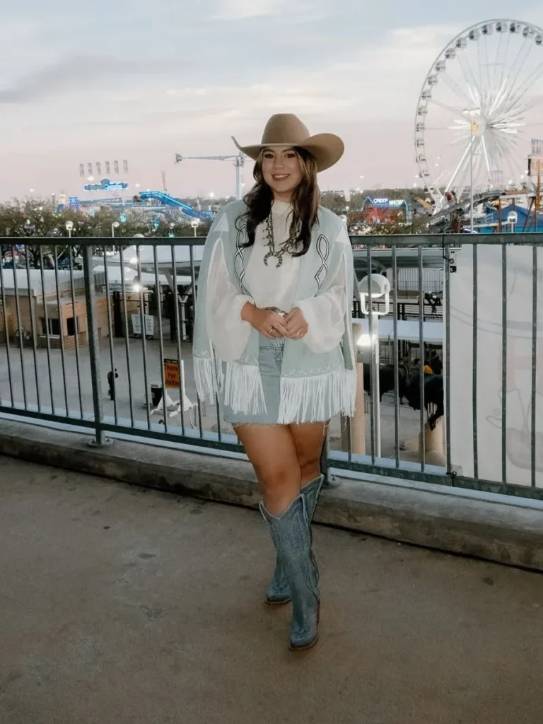 White Blouse with a Blue Fringe Vest and Denim Shorts