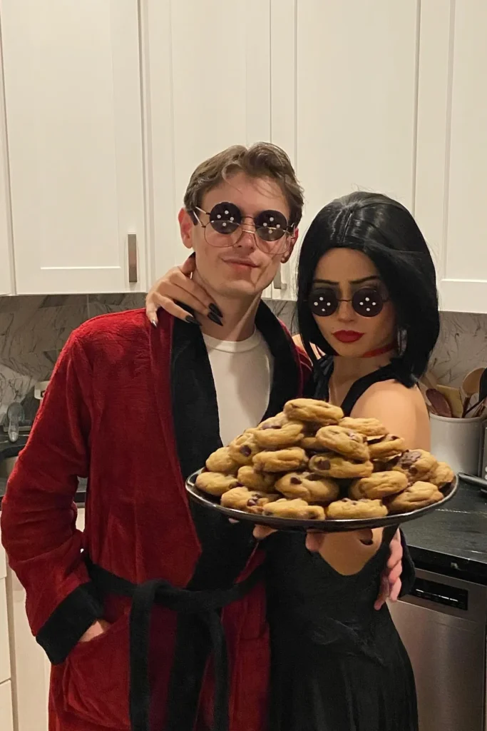 Red Robe with Black Trim and Black Dress with Round Sunglasses